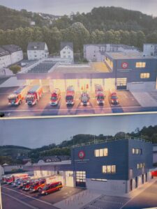 Bild zeigt das neue Feuerwehrgerätehaus Werdohl Stadtmitte aus der Luftperspektive mit Einsatzwagen.